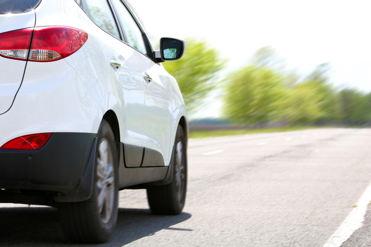 A white crossover on the road