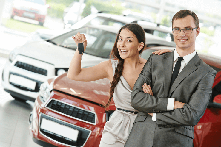 A woman with a dealer selling a car