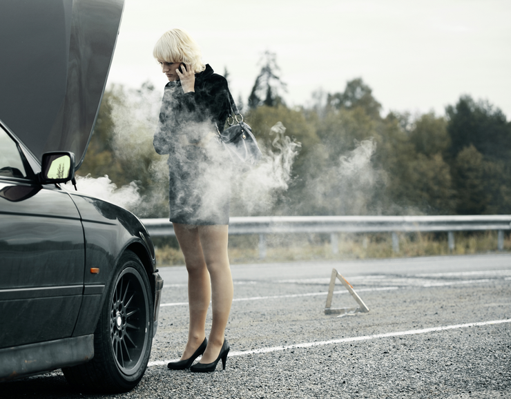 A woman with her overheated car engine calling for help