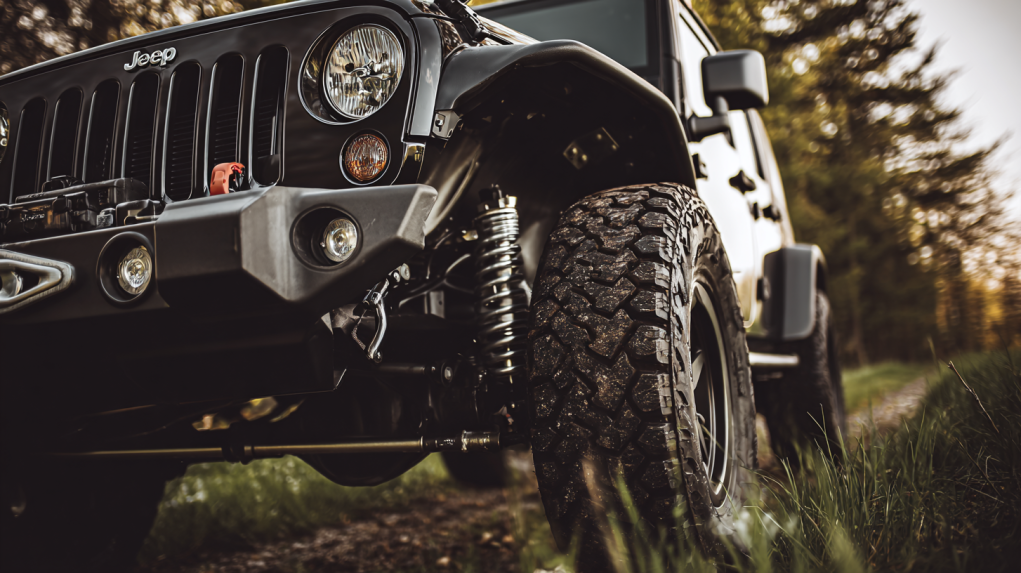 Close-up of Jeep wheel and suspension components.